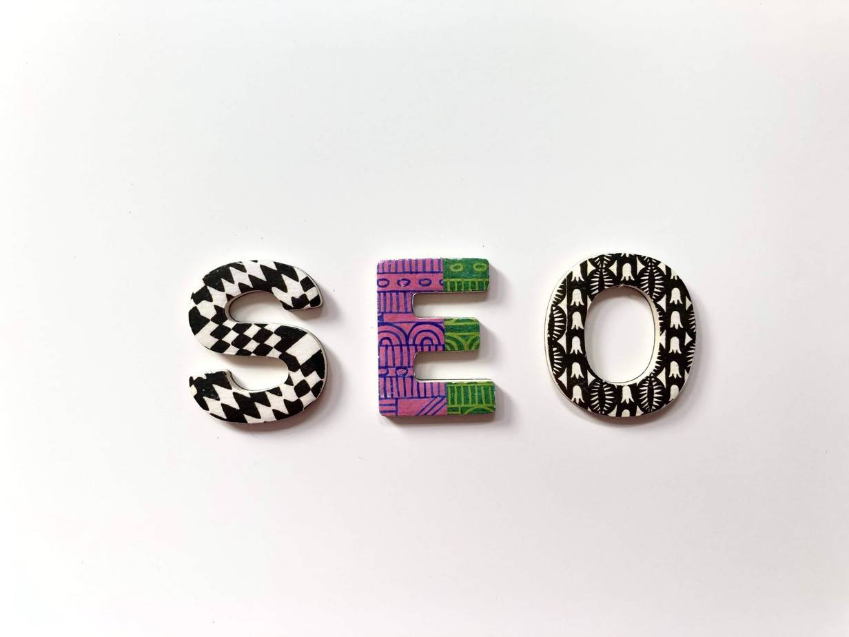 Colourful SEO letters on a white surface