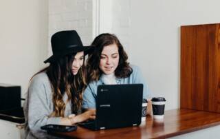 women working on laptop together